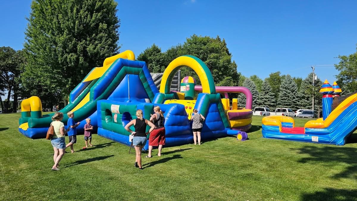 Children and families enjoying a colorful inflatable obstacle course