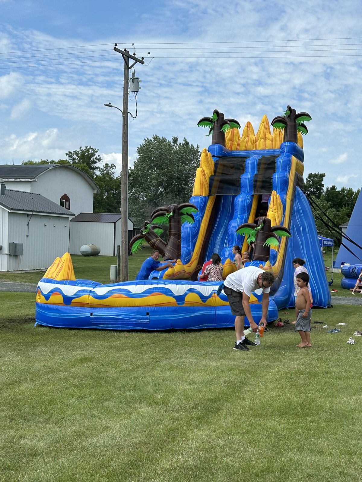 Child enjoying a large tropical inflatable water slide