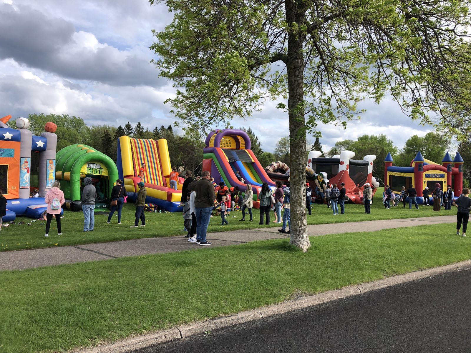 A long row of inflatable attractions at a Minnesota park event