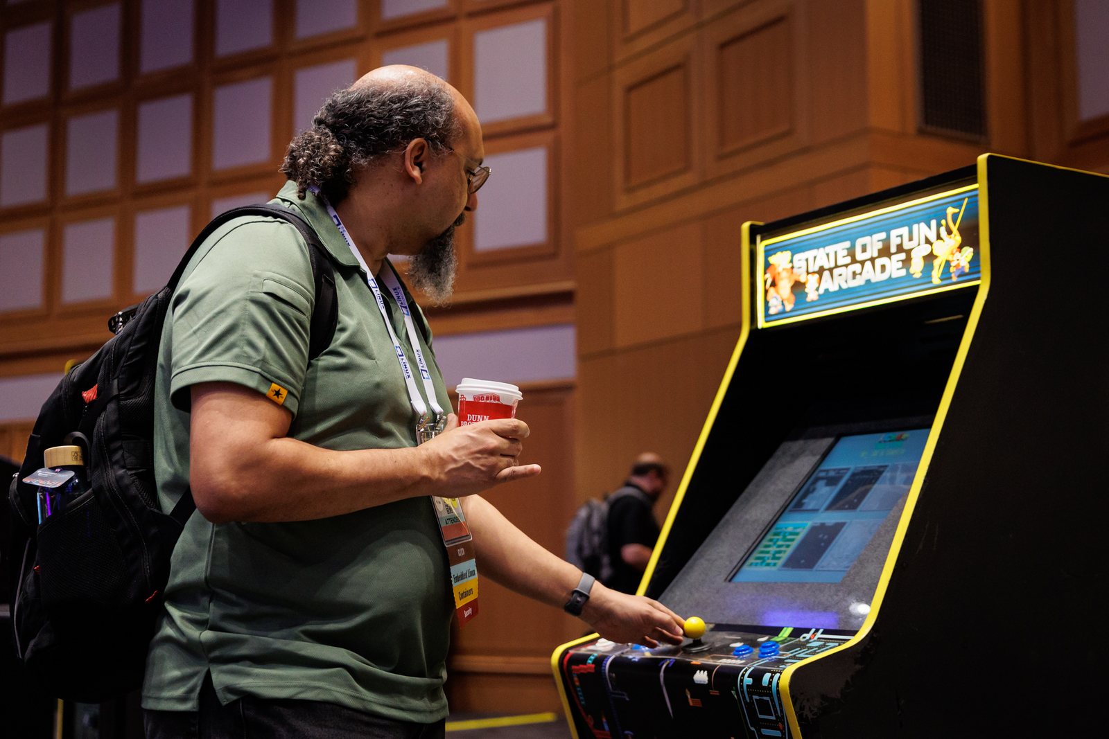 Corporate attendee playing a State of Fun arcade game