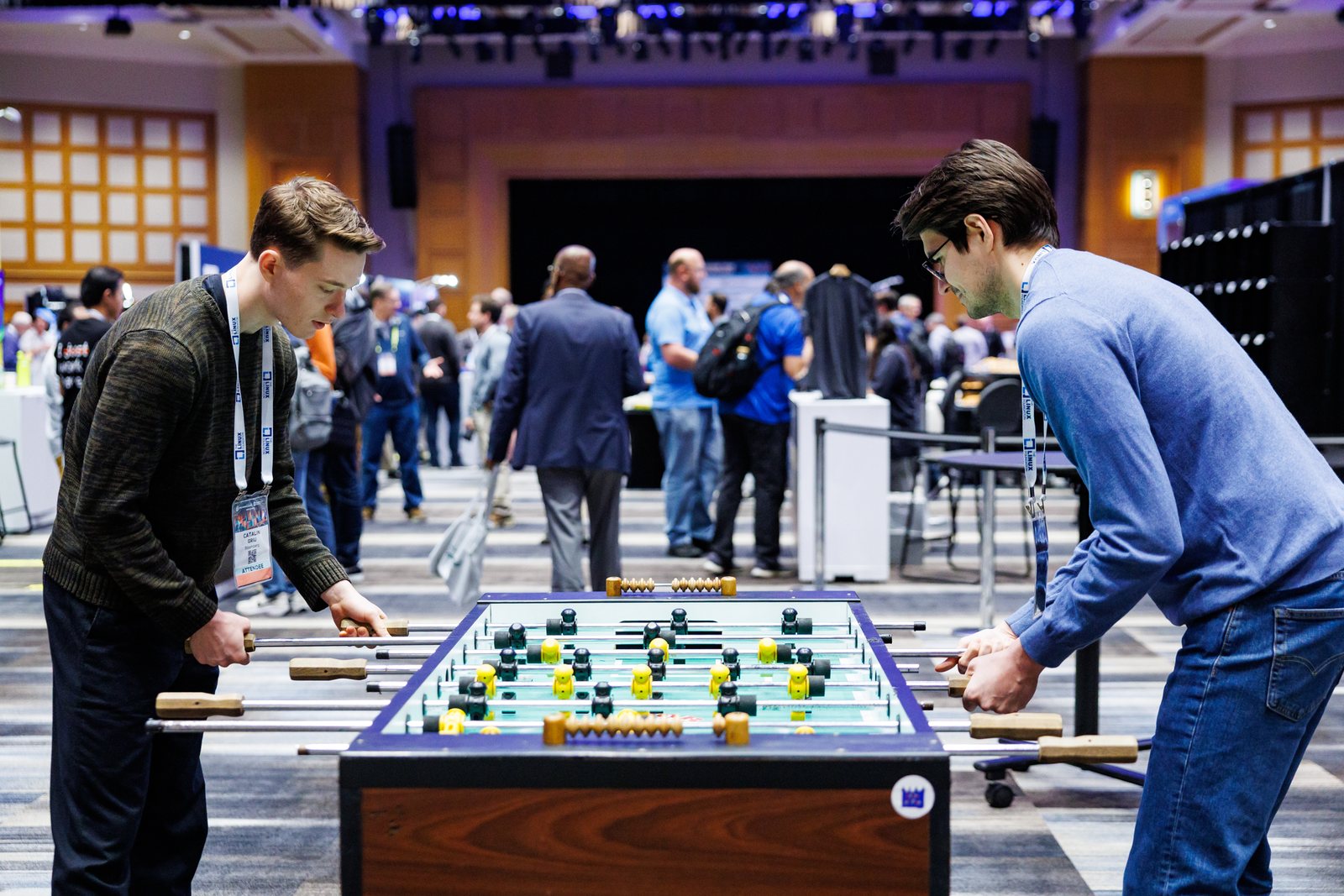 Two corporate event attendees competing at foosball