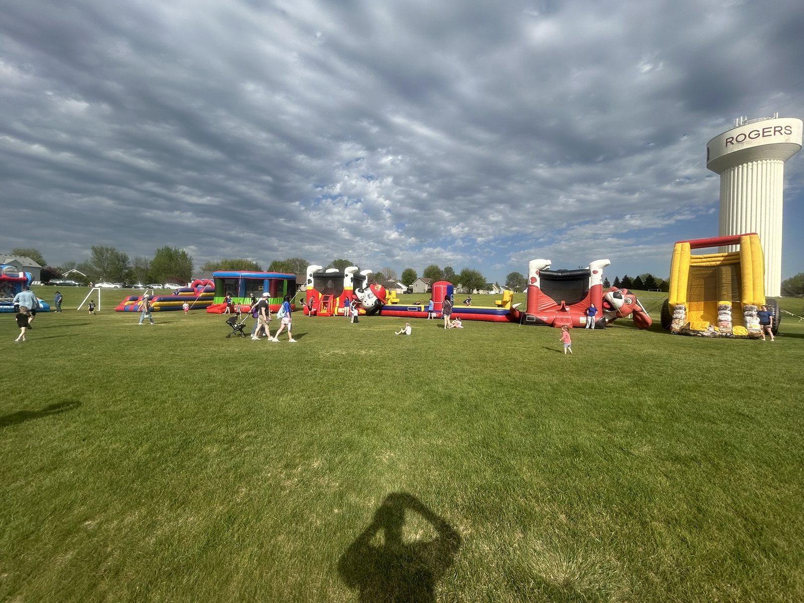 Multiple inflatable attractions set up across a school field