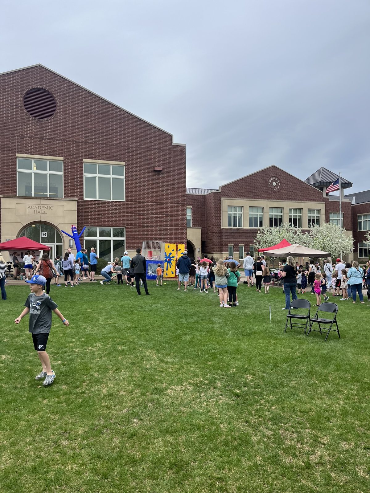 Families gathered outside for a State of Fun school fundraiser